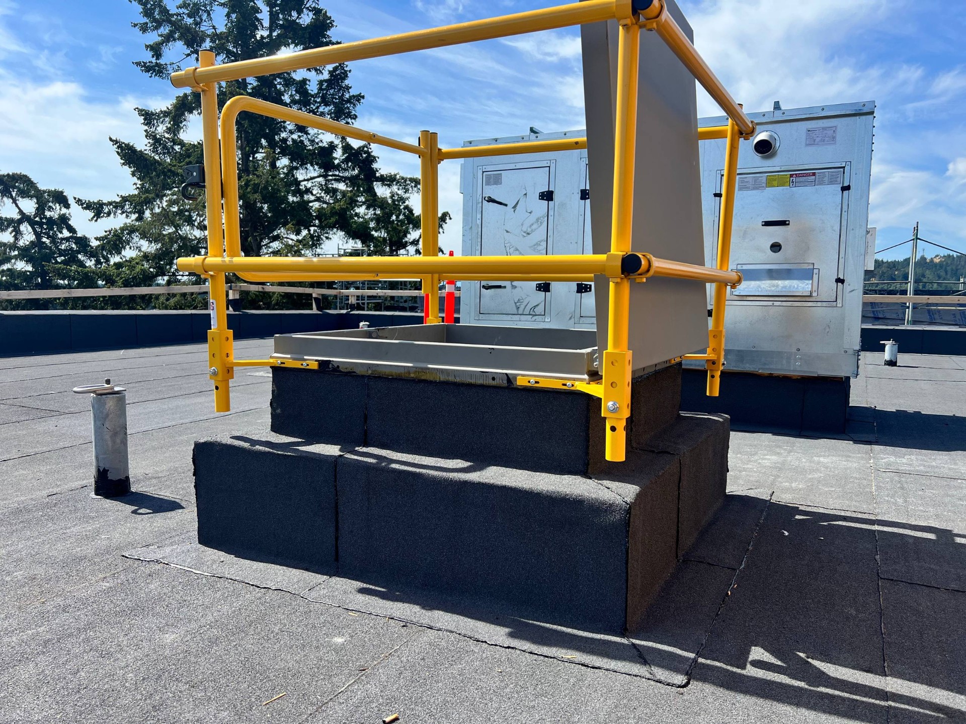 Roof hatch with safety railing on a finished roof