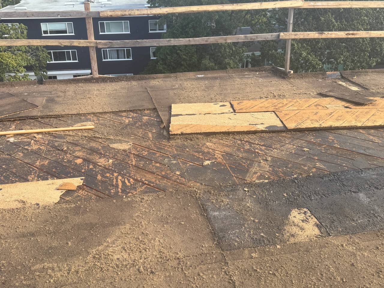 Old roofing torn off exposing the wood deck